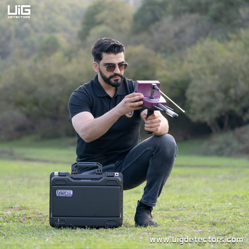 UIG Titan 500 smart device for detecting gold, metals, gemstones, and diamonds, shown in gold with metal and gemstone features.