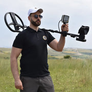 UIG Gold Digger device for detecting gold and precious metals, shown as a handheld metal detector in use.